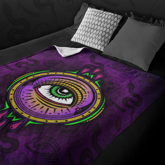 All Seeing Eye design with a purple patterned background on a velveteen blanket displayed on a black bed with pillows. 