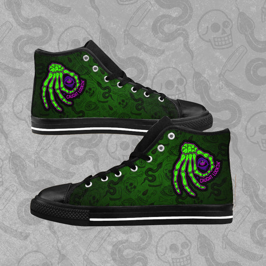 Caught Lookin' design printed on the outside panel of rubber toed, high-top sneakers. Green and black Blood Hex pattern all over print background. 