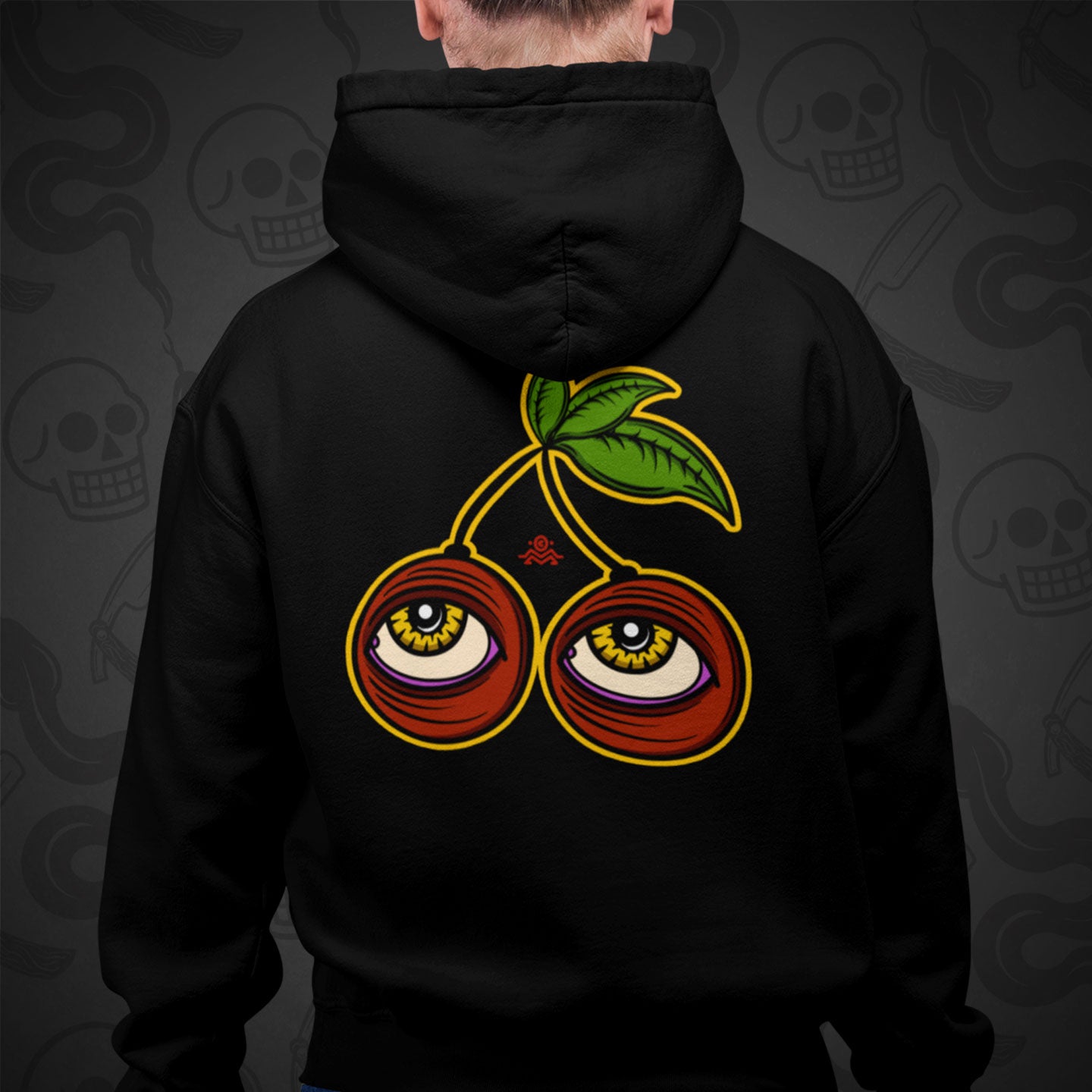 Cropped image of a Model wearing a black zippered hoodie with Cherry Cherry design printed on the back with vibrant colors.