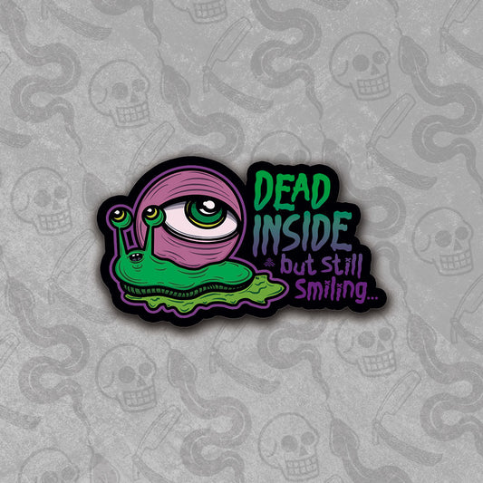 Die-cut Dead Inside But Still Smiling sticker design with vibrant colors.