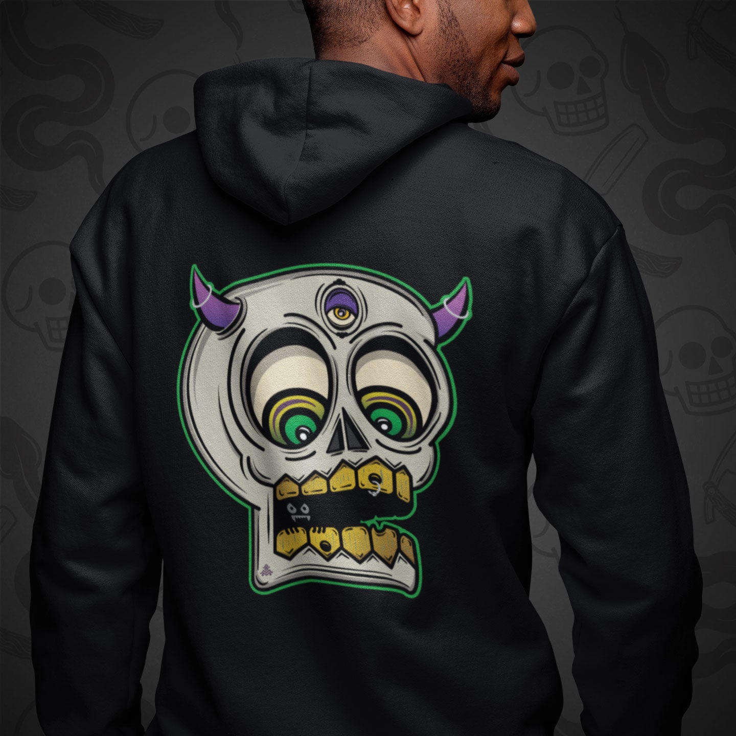 Cropped image of a Model wearing a black zippered hoodie with Demon Skull design printed on the back with vibrant colors.