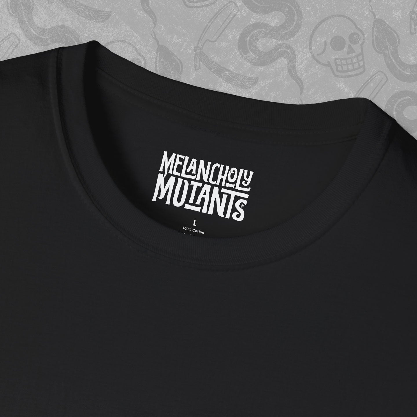 White Melancholy Mutants logo printed on the inner neck label of a black t-shirt. 