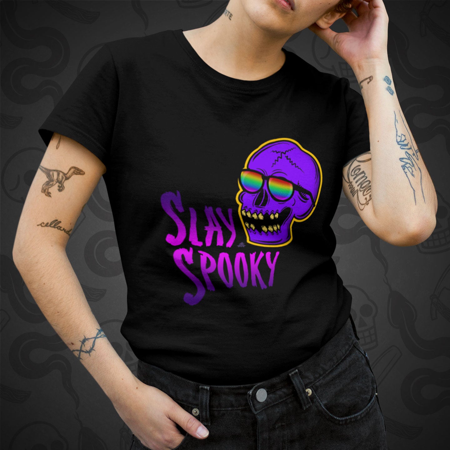 Cropped image of a model wearing black t-shirt with the Slay Spooky design printed on the front with vibrant colors.