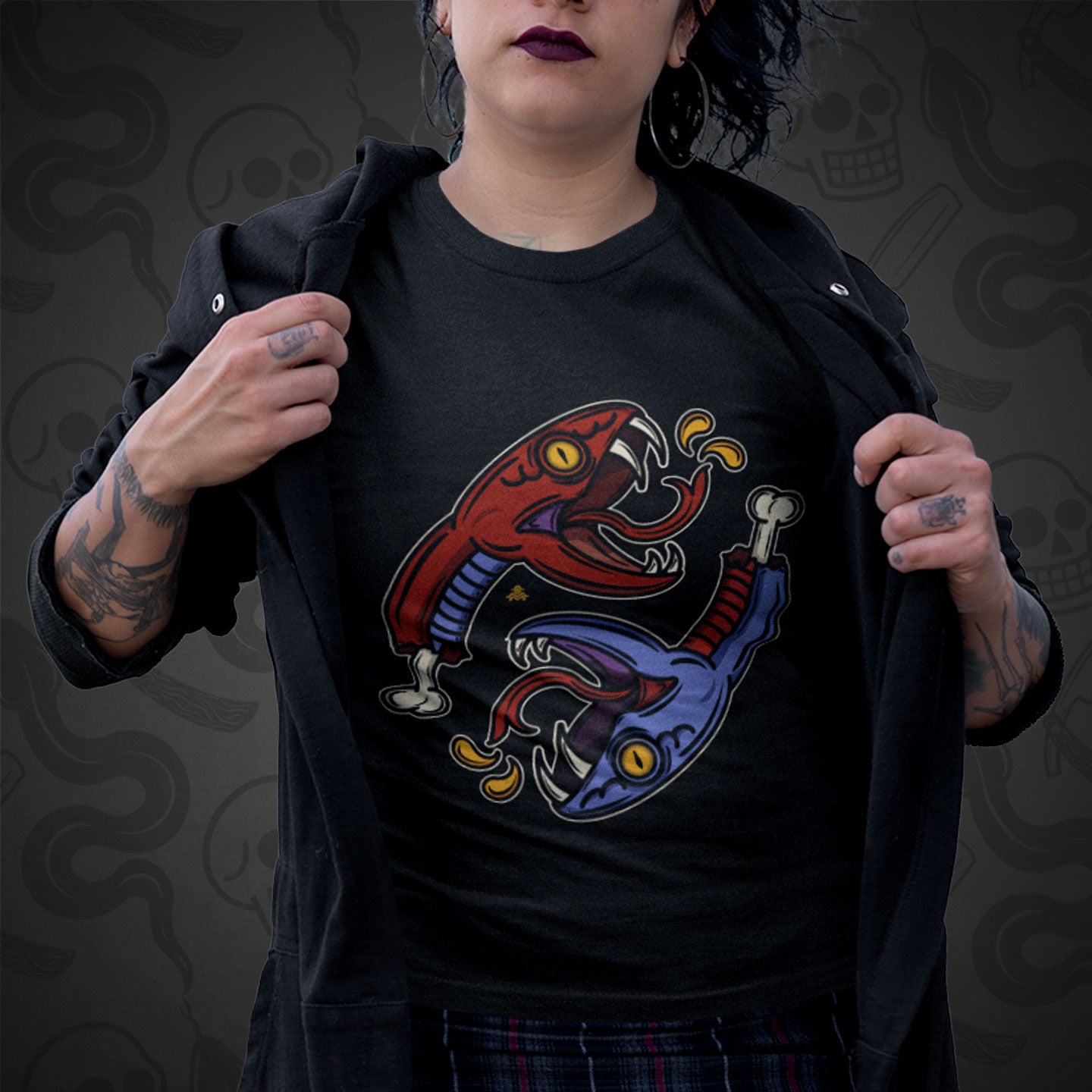 Cropped image of a model wearing black t-shirt with the Snake Bite design printed on the front with vibrant colors.