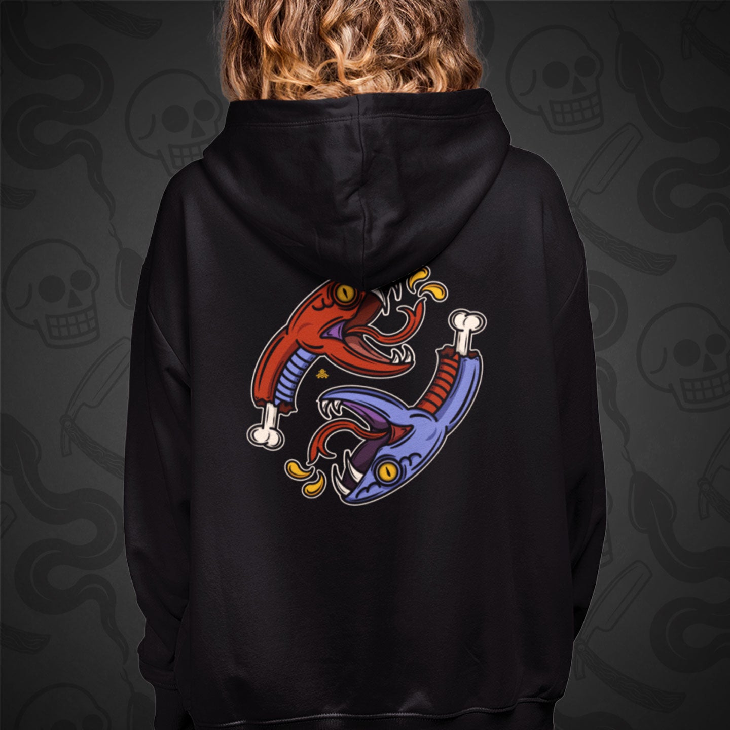 Cropped image of a Model wearing a black zippered hoodie with Snake Bite design printed on the back with vibrant colors.