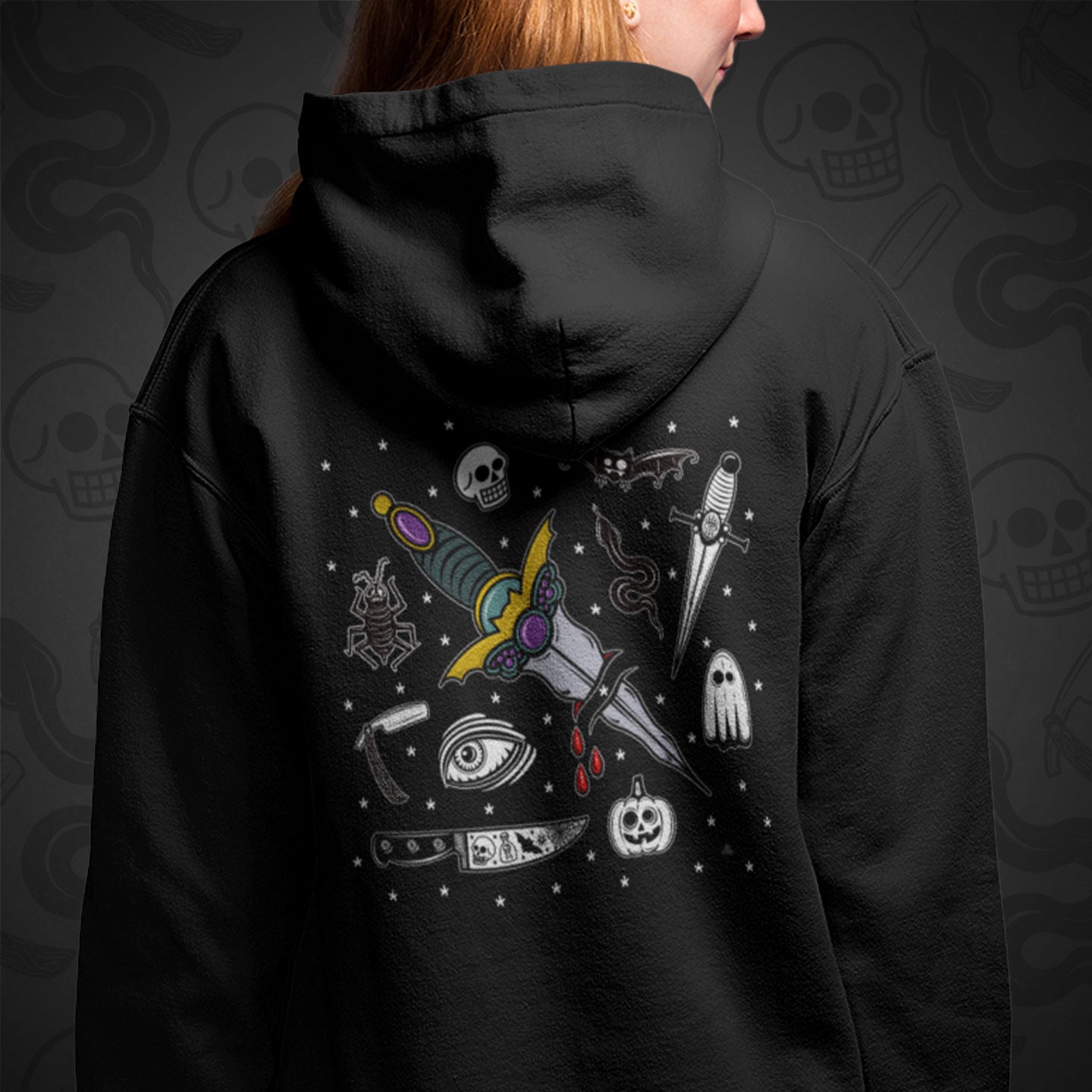 Cropped image of a model wearing a black zippered hoodie with The Ritual design printed on the back with vibrant colors.